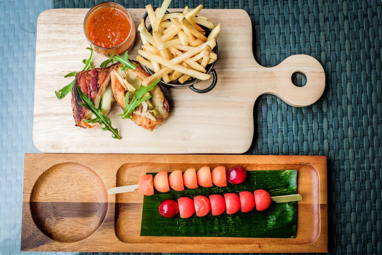 Fusion Suites Phuket Patong Esterno foto A wooden cutting board with a handle