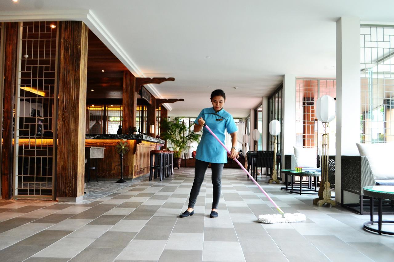Fusion Suites Phuket Patong Esterno foto A hotel housekeeper mopping the floor